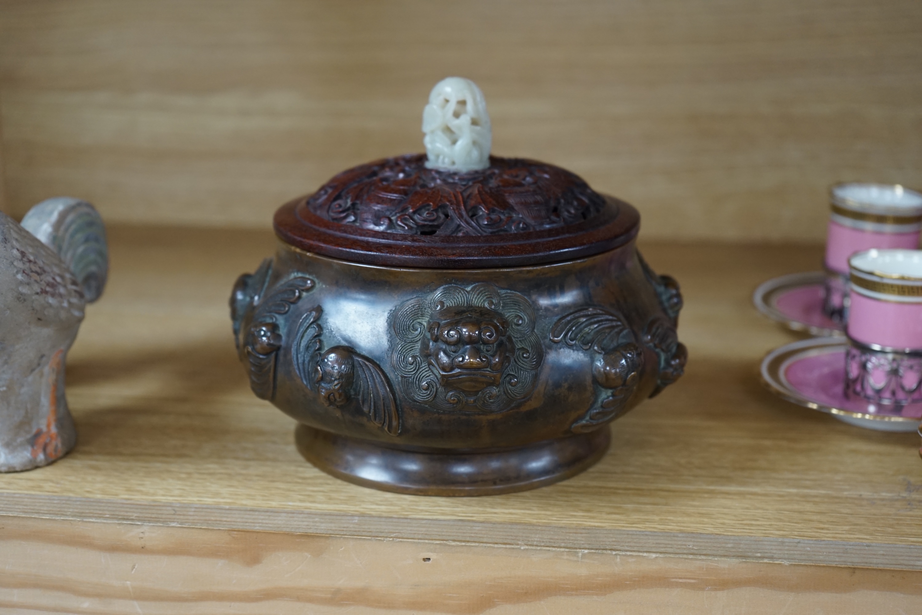 A Chinese bronze censer, with carved wooden cover and jade finial, 17cm high. Condition - good